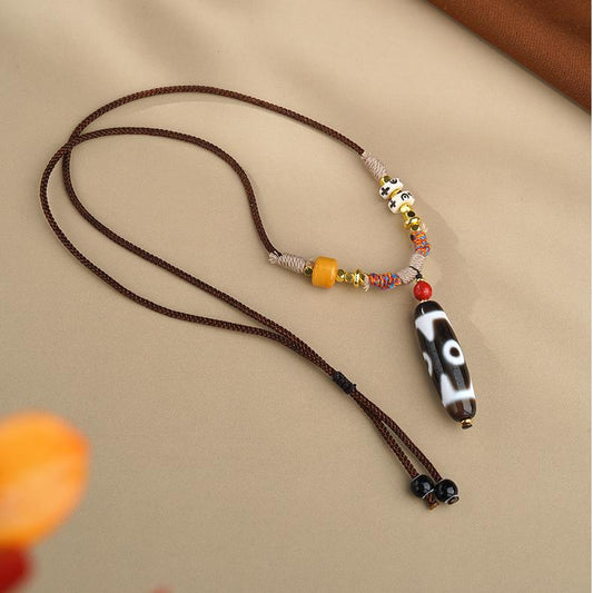 Handcrafted Tibetan Buddhist three-eye agate necklace with copper pendant, inspired by traditional thangka painting and Himalayan spiritual art.