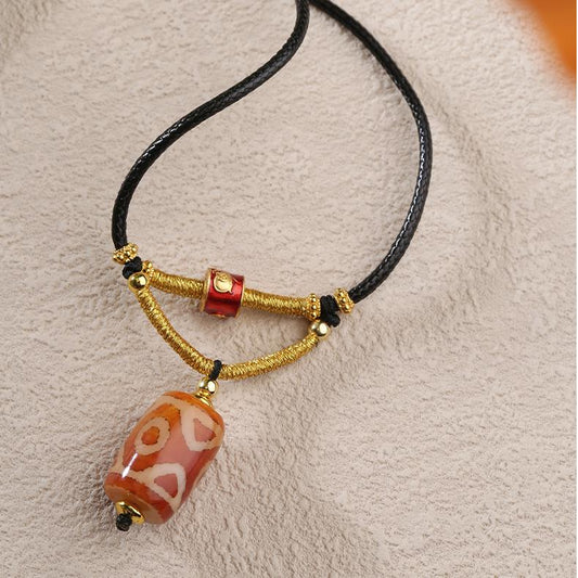 Tibetan three-eye agate necklace with copper alloy details, a spiritual Buddhist jewelry piece reflecting Tibetan Thangka art and sacred energy.