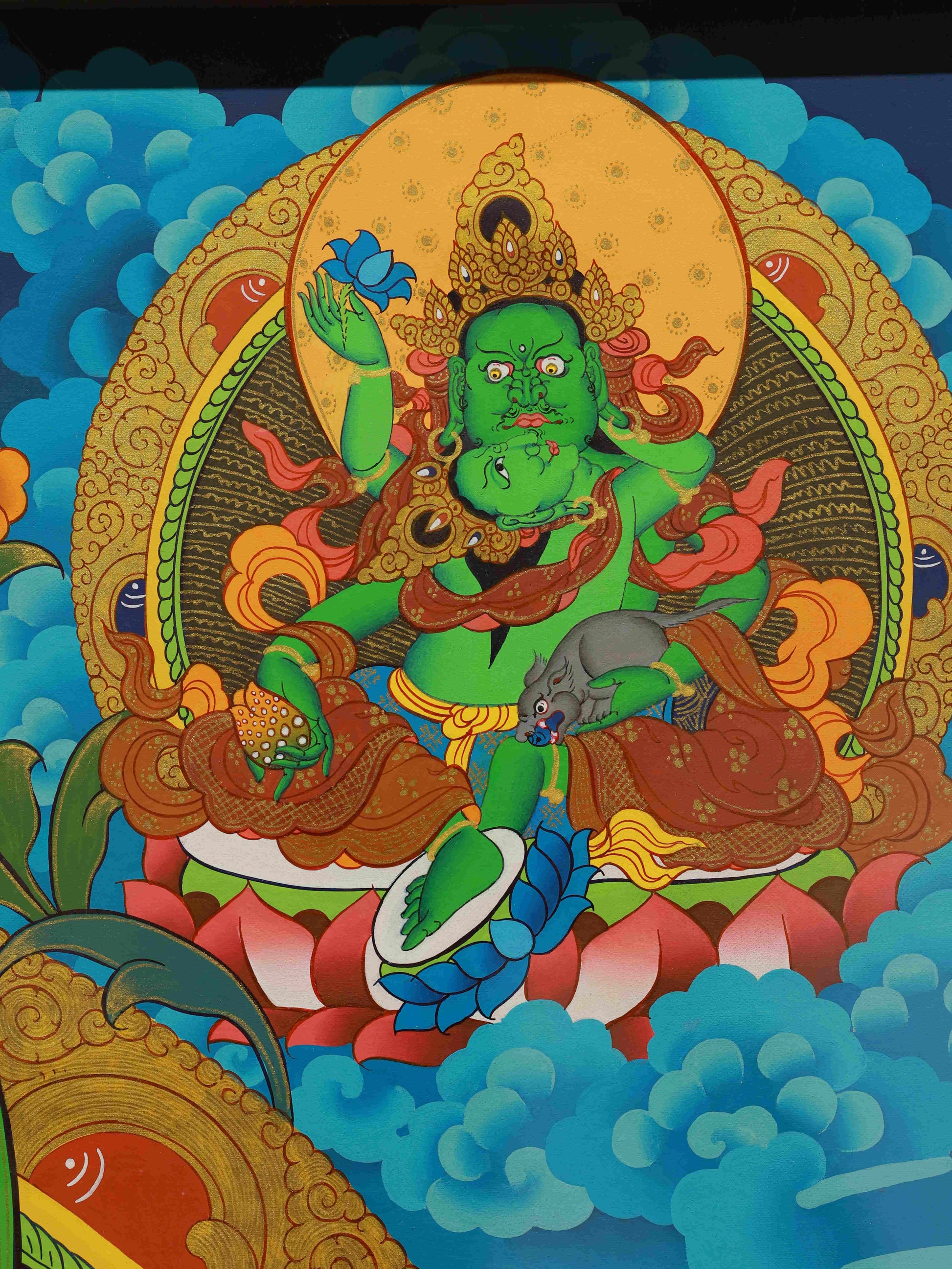 Authentic handmade Tibetan Thangka of Yellow Dzambhala, deity of wealth and generosity.