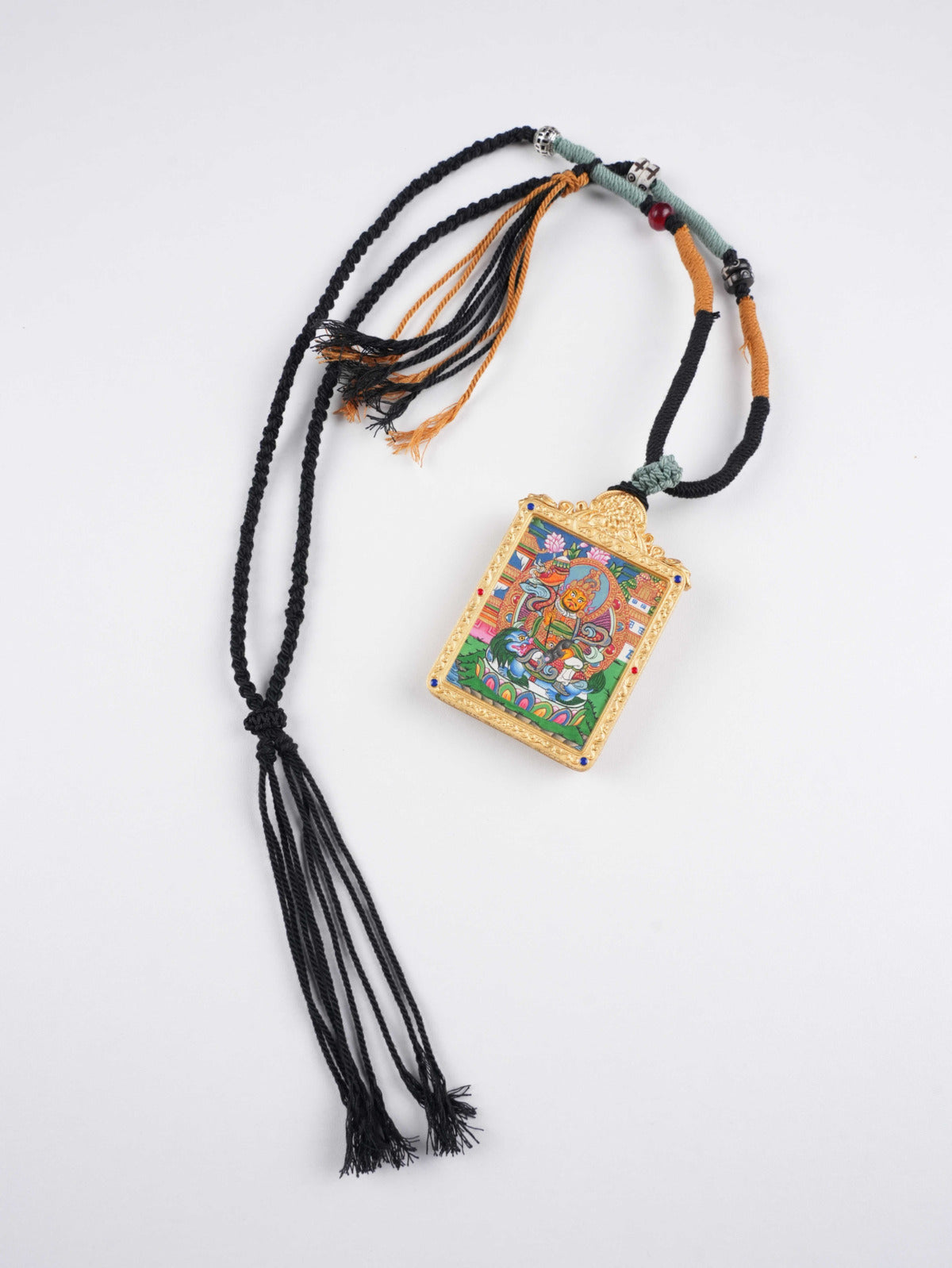 Hand-painted Tibetan Buddhist Wealth King Dzambhala thangka pendant on traditional thangka canvas with mineral pigments, symbolizing prosperity and spiritual protection.