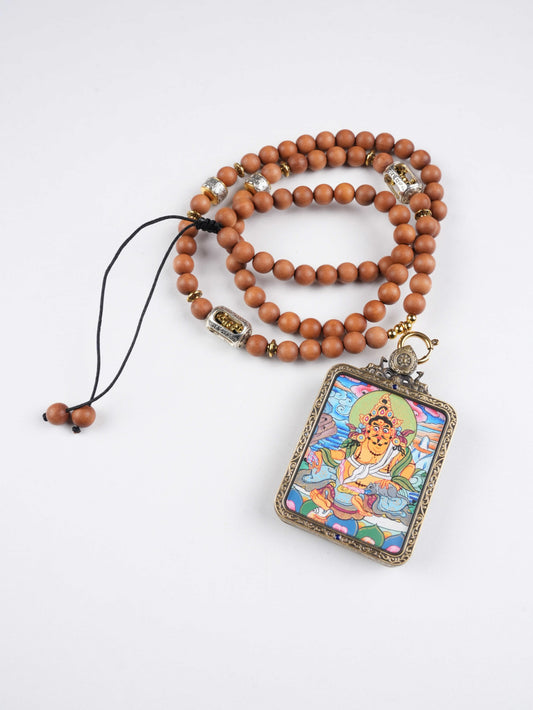 Hand-painted Tibetan Buddhist Wealth King Dzambhala thangka pendant crafted on traditional thangka canvas with mineral pigments, symbolizing prosperity and protection.