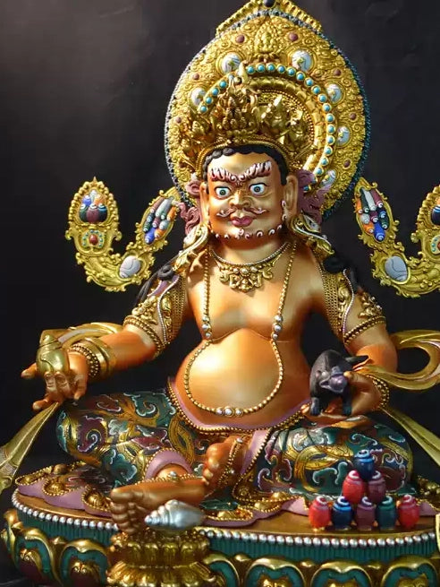 Tibetan Buddhist Yellow Jambhala Buddha statue art, adorned with golden mineral pigments. It serves as a powerful focal point for inviting abundance and spiritual blessings.