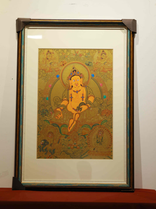 Tibetan Buddhist Thangka painting of Yellow Dzambhala, handcrafted with mineral pigments on thangka canvas.