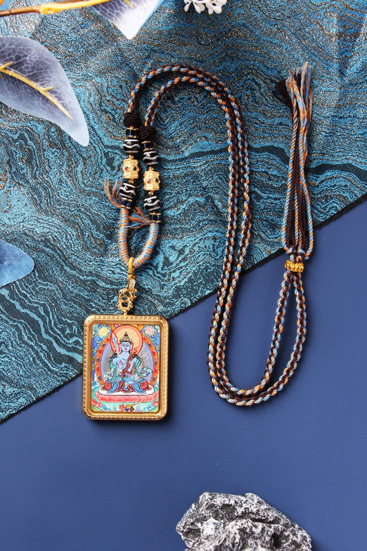 A collection of hand-painted Rebgong Thangka pendants including Avalokiteshvara and wrathful protectors in silver and gold frames.