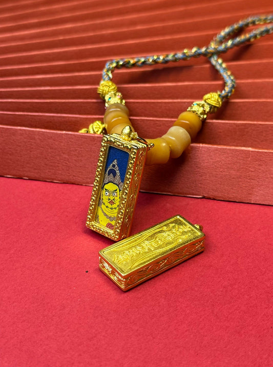 The King of Wealth Deities: Rekong Yellow Jambhala Thangka Pendant with Copper Casing