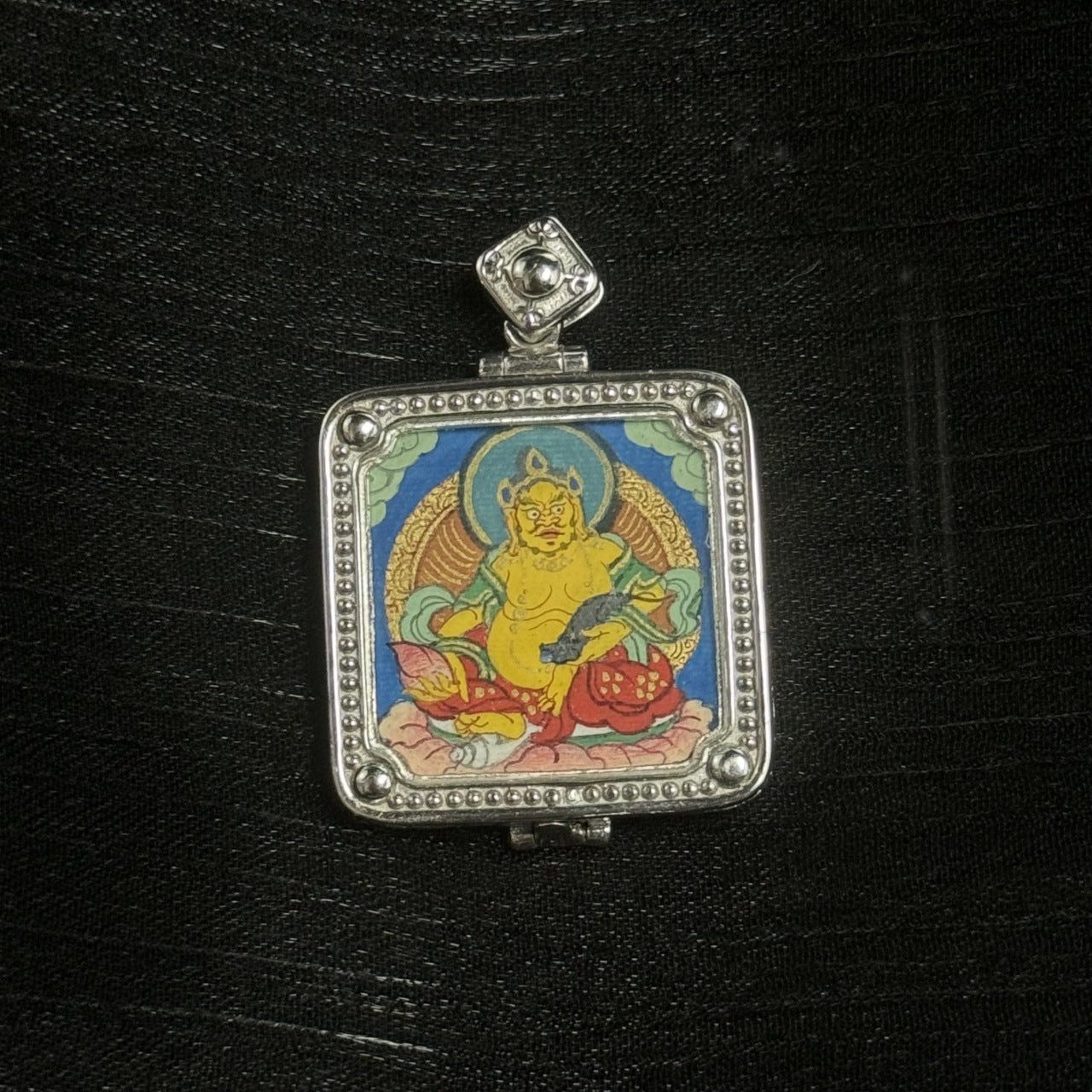  Close-up detail of the Rebgong Small Card Yellow Jambhala Thangka painting showing intricate natural mineral pigment work, showcasing the masterful artistry of Rebgong lineage painters.

