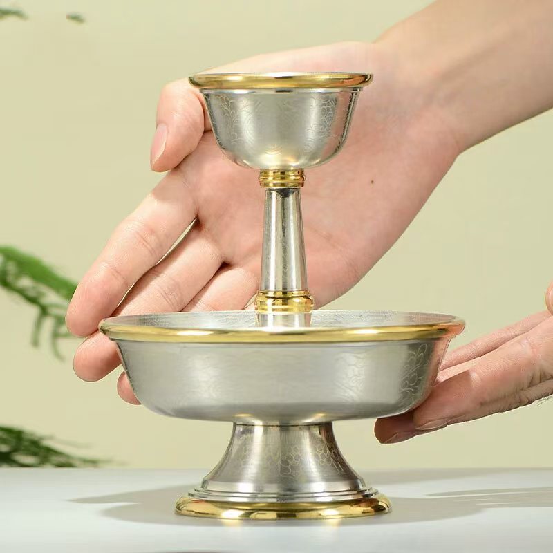 Tibetan Buddhist sacrificial implements culture: Detailed view of a handmade copper chalice featuring Buddhist sacrificial items art and traditional Himalayan textures.
