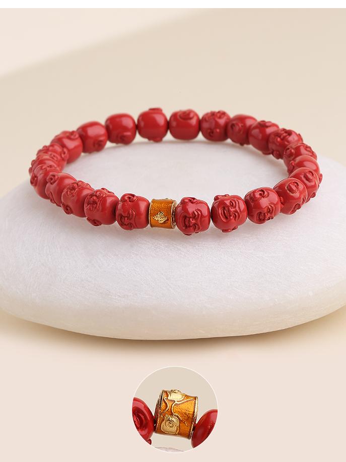 Detail of the hand-painted Buddha figure on a vibrant cinnabar bead bracelet. This item is part of a spiritual jewelry art collection rooted in Tibetan Buddhist tradition.