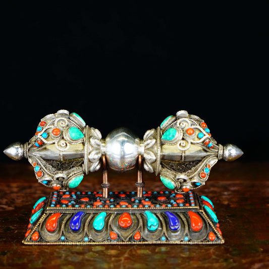 Meticulously handcrafted pure silver Vajra, symbolizing spiritual power and the transformative energy in Tibetan Buddhist ritual implements art.