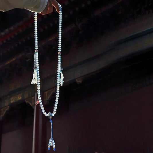 Tibetan Buddhist Jewelry Culture: A handmade natural aquamarine and pearl 108 mala beads necklace, showcasing sacred jewelry art and tranquility.
