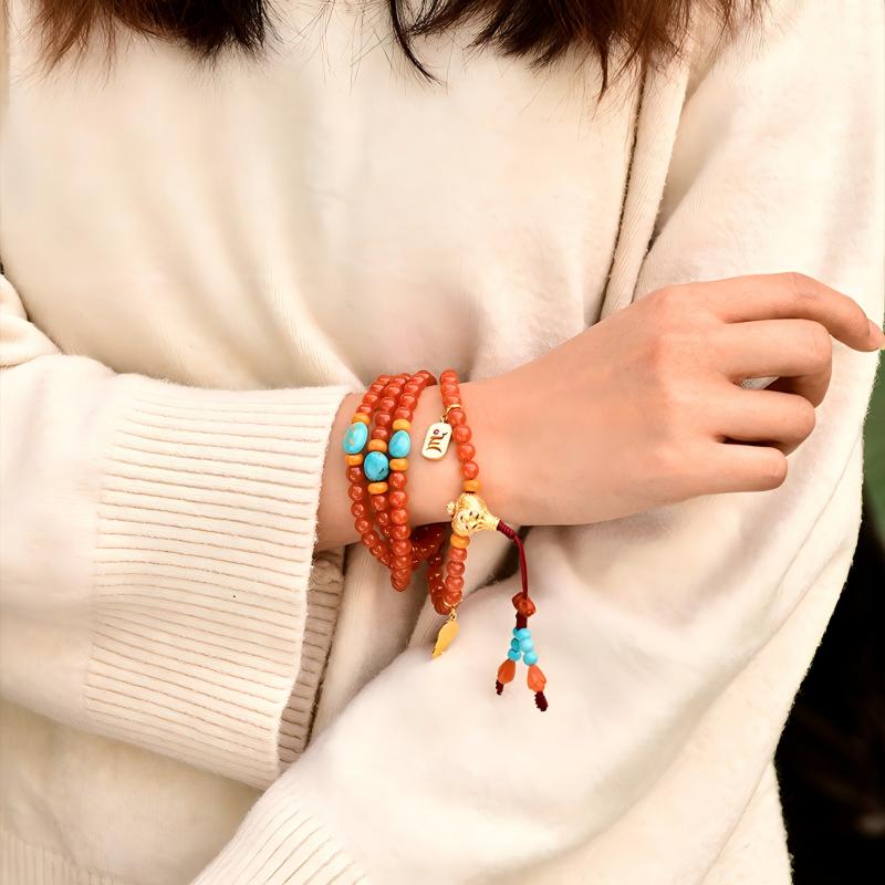 Tibetan Buddhist Jewelry Culture: A handmade natural Cherry Red Nan Hong Agate 108 mala beads necklace, showcasing sacred Buddhist jewelry art and vitality.