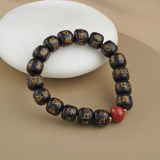 Handmade ebony and red sand prayer bead bracelet, showcasing the unique charm of Tibetan Buddhist jewelry culture.