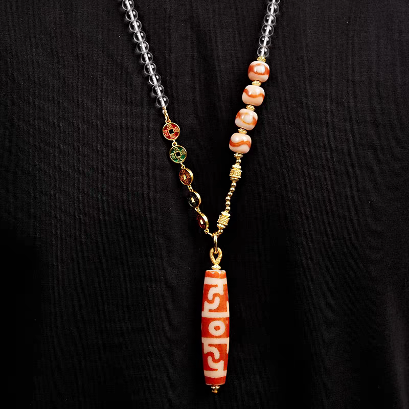 Tibetan Buddhist Jewelry Culture red meat agate pendant with Lotus Guru Rinpoche and ritual implements. A masterpiece of jewelry art. Source
