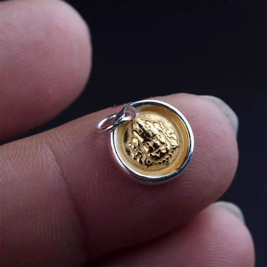 Tibetan Buddhist Jewelry Culture gold-plated silver Yellow Jambhala (Wealth God) side pendant. A sacred piece of jewelry art for prosperity. Source
