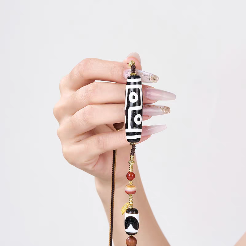 Authentic handmade Panda black and white six-eye Dzi amulet, showcasing jewelry art and Tibetan Buddhist Jewelry Culture.