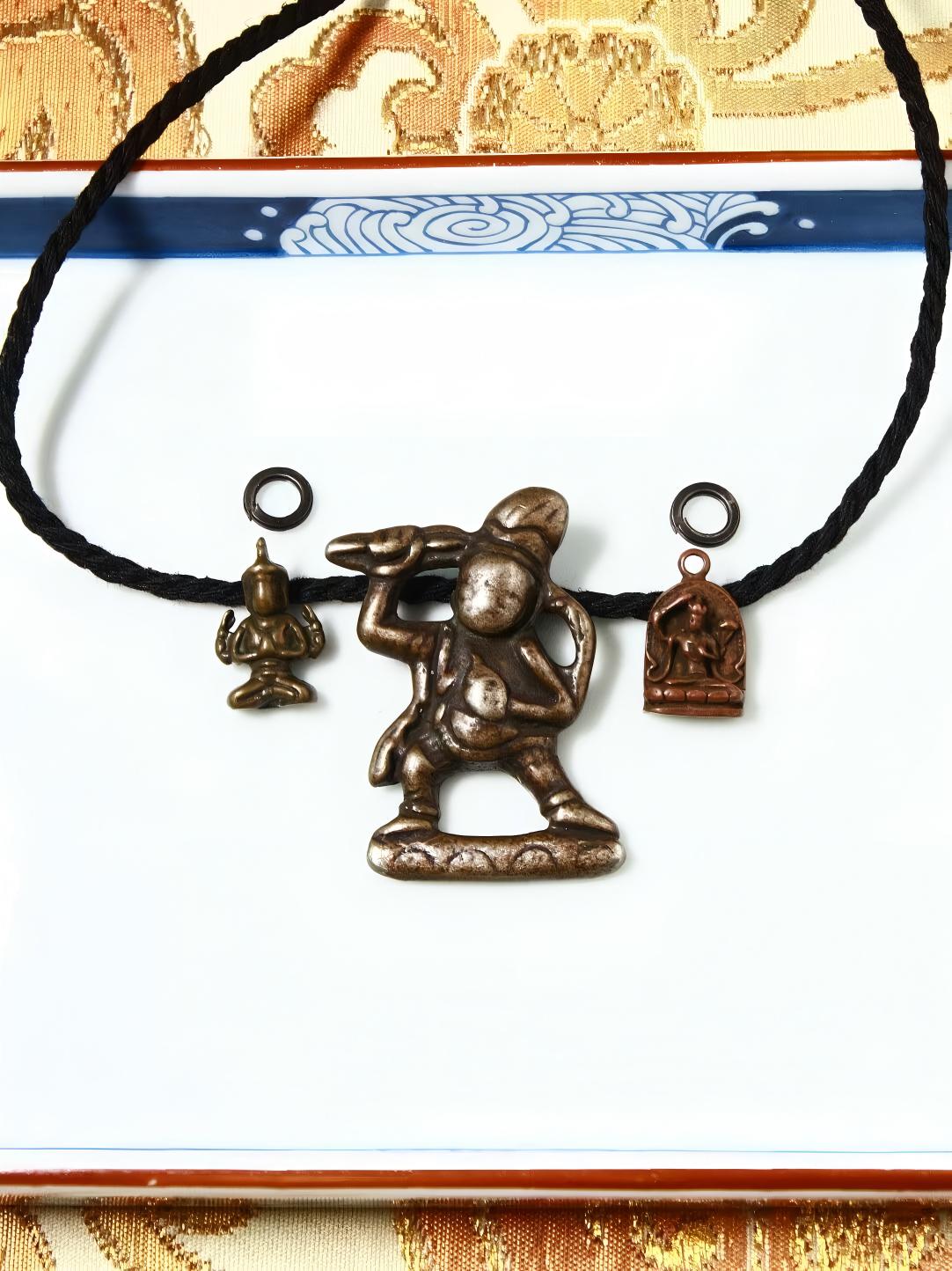 Hand-painted Iron figure of Black Jambhala and Yellow Jambhala side hanging, symbolizing wealth and prosperity in Tibetan Buddhist Jewelry Art, meticulously crafted.