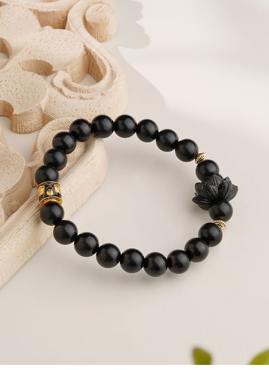 Hand-painted ebony lotus bead bracelet, showcasing a unique artistic style infused with the spiritual essence of Tibetan Buddhism, an ideal aid for meditation.