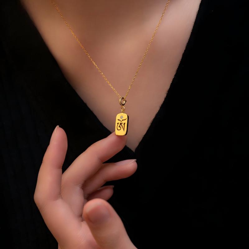 Hand-painted silver seed syllable amulet, showcasing Tibetan Buddhist Jewelry Culture and artisan Jewelry art.
