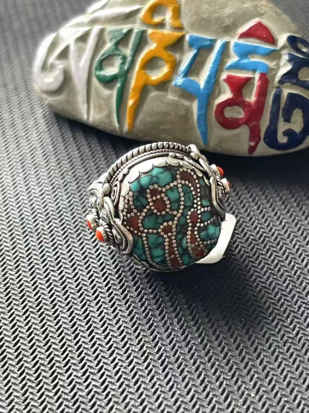 Traditional Tibetan Buddhist Jewelry Culture accessory, 925 silver turquoise ring with handmade engravings and expert jewelry art craftsmanship.