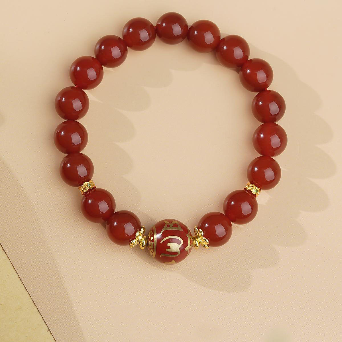 Pure handmade red agate mala bracelet, adorned with traditional Tibetan Buddhist sacred symbols. Each piece is a unique work of jewelry art, conveying blessings and tranquility, ideal for mantra recitation or as a spiritual accessory.