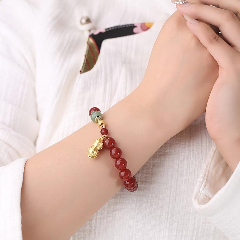 Making process of Artisanal Morning Blossom Carnelian Bracelet. Shows artisan hand-painting agate beads, demonstrating perfect fusion of traditional craftsmanship and modern aesthetics.