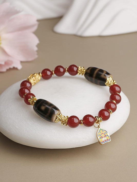 Tibetan Buddhist Jewelry Art: Hand-Painted Red Agate Dzi Beads Bracelet for spiritual growth and positive energy in Tibetan Buddhist tradition