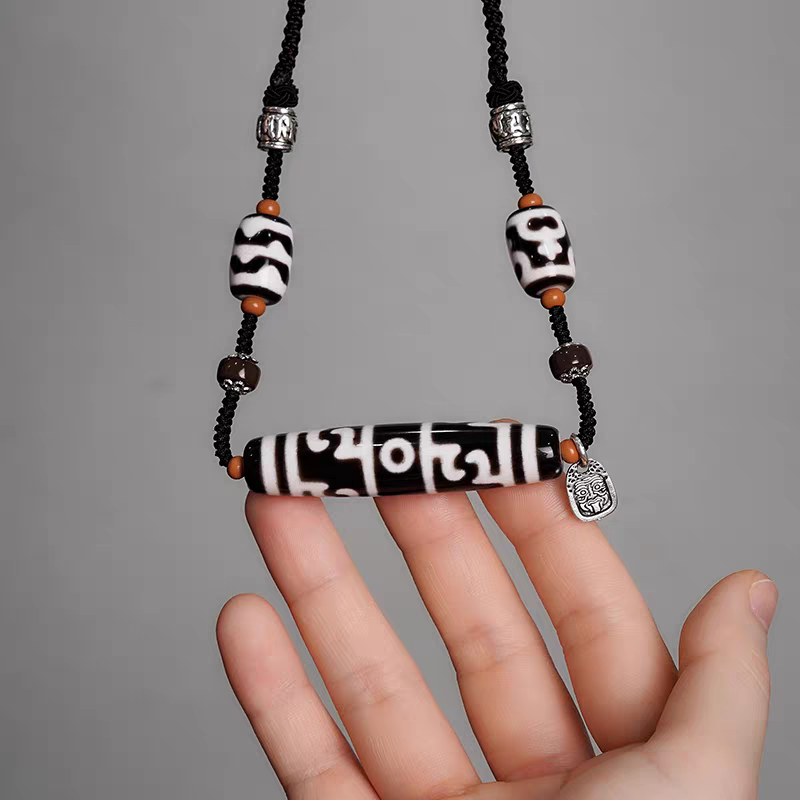 Exquisite multi-totem ritual implements Dzi jewelry, a spiritual artifact rooted in Tibetan Buddhist Jewelry Culture for protection.

