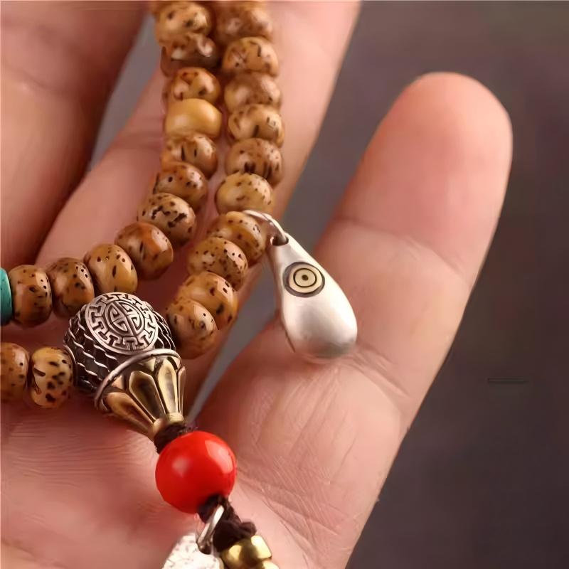 Authentic handmade silver Tibetan deer tooth bead, showcasing jewelry art and Tibetan Buddhist Jewelry Culture. Purely handcrafted.
