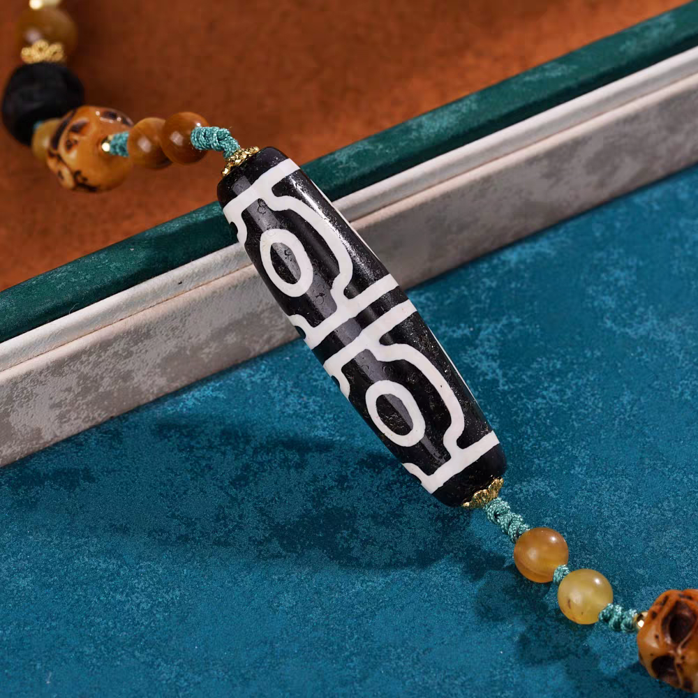 Authentic handmade Panda black and white four-eye Dzi bead, showcasing jewelry art and Tibetan Buddhist Jewelry Culture.