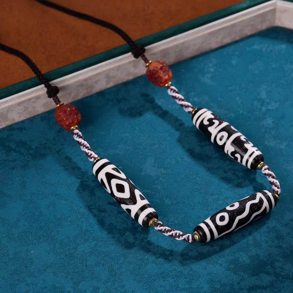 Exquisite six-eyed natural agate Dzi jewelry with phoenix eye pattern, a spiritual artifact rooted in Tibetan Buddhist Jewelry Culture for wisdom.