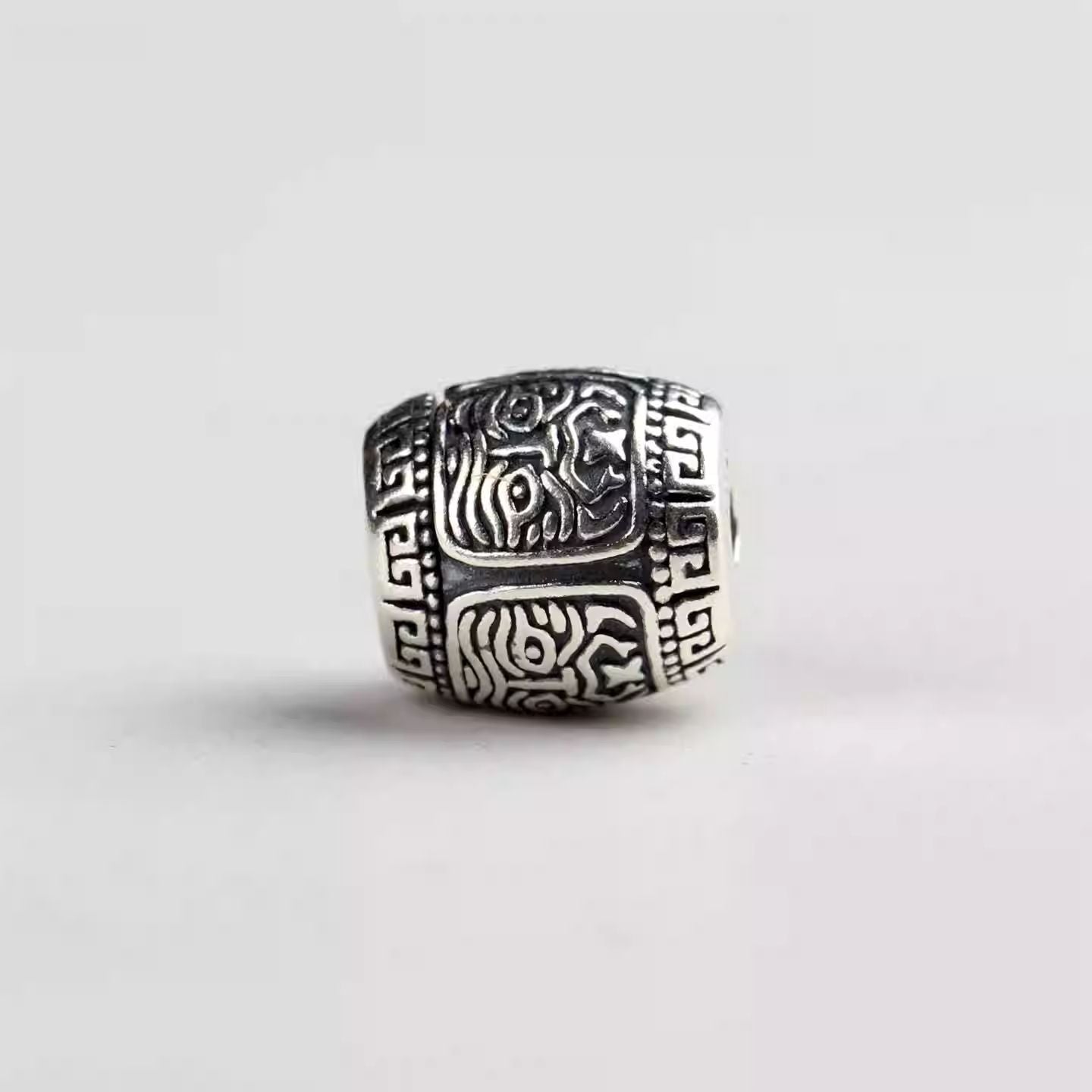 Authentic handmade silver Zhakiralam wealth deity spacer, showcasing jewelry art and Tibetan Buddhist Jewelry Culture. Purely handcrafted.
