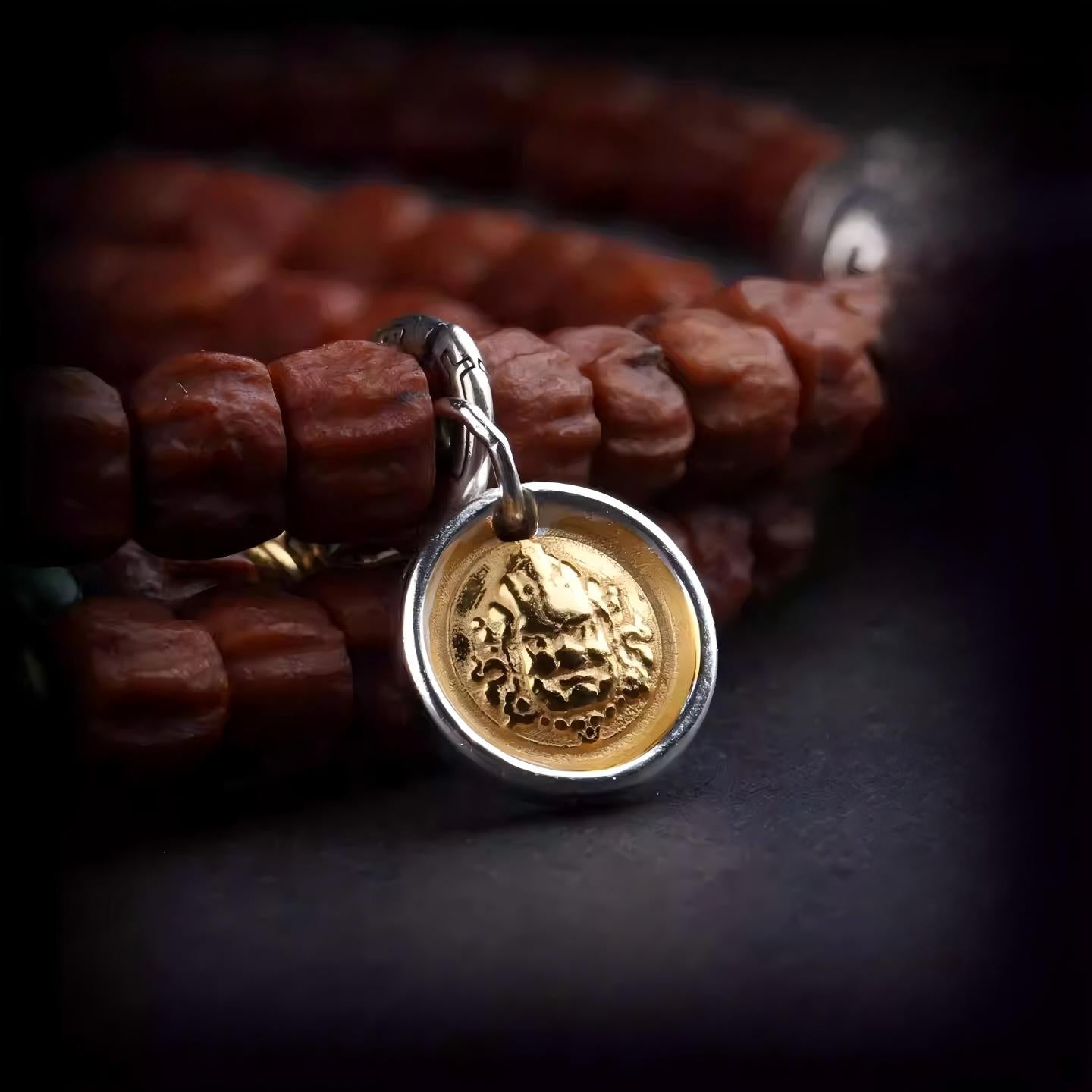 Exquisite Yellow Jambhala spiritual jewelry in gold-plated silver, a rare artifact rooted in Tibetan Buddhist Jewelry Culture for financial luck.
