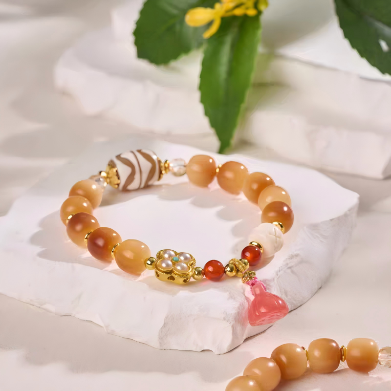 Handcrafted Tibetan Buddhist twin tiger tooth Dzi beads bracelet, a unique jewelry art piece for spiritual protection and positive energy.