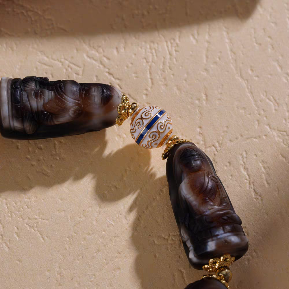 Handmade F Medicine Carved Dzi bracelet, promoting spiritual balance, positive energy, and prosperity in Tibetan Buddhist jewelry art.