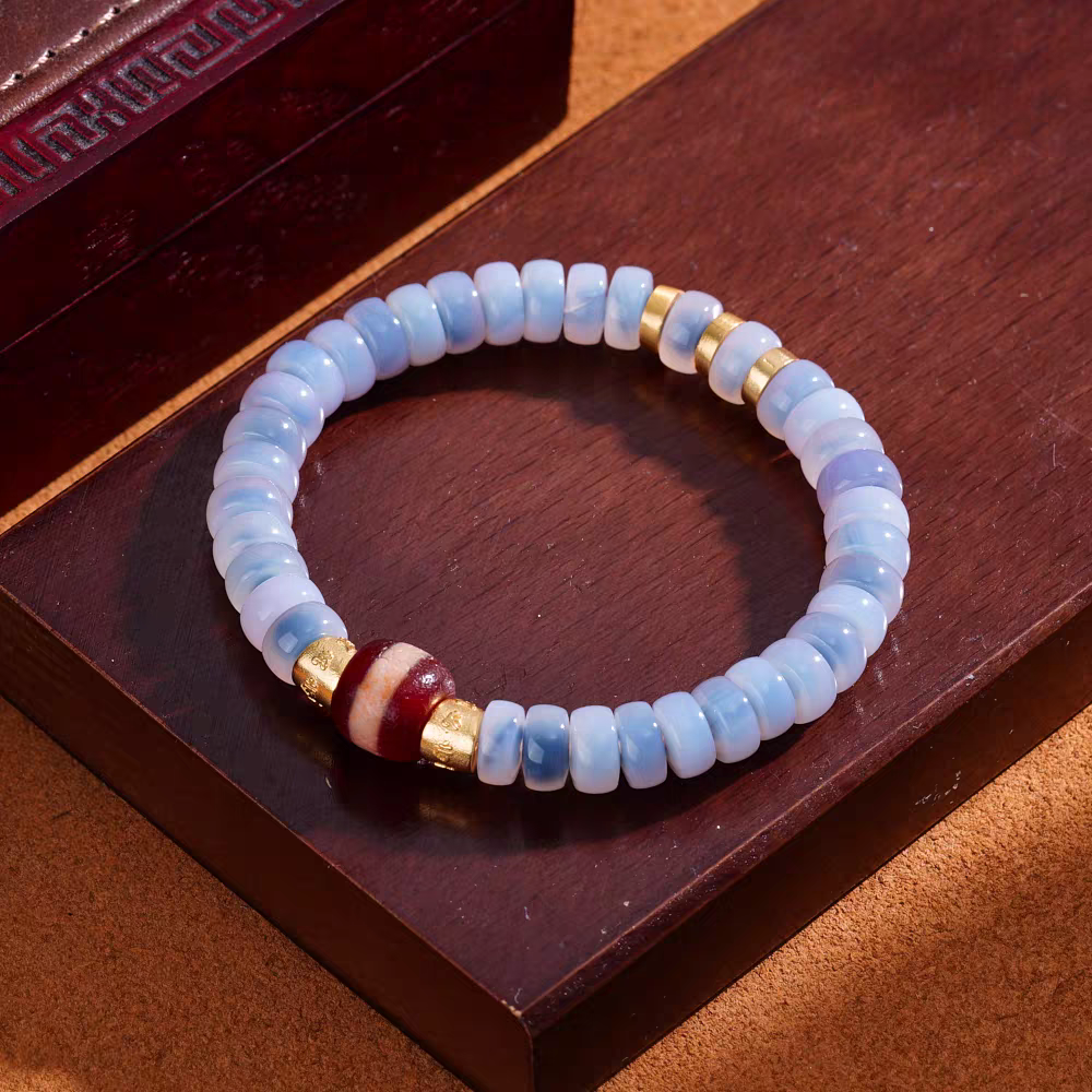  Handmade red agate single-line Medicine Buddha bead featuring exquisite blue bubble hand-painted motifs, rooted in Tibetan Buddhist Jewelry Culture and jewelry art.