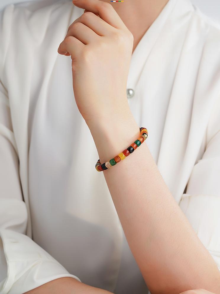 Authentic Tibetan Buddhist Jewelry Art featuring a handmade Dark Agate Jambhala Bracelet, a sacred talisman for wealth and protection.