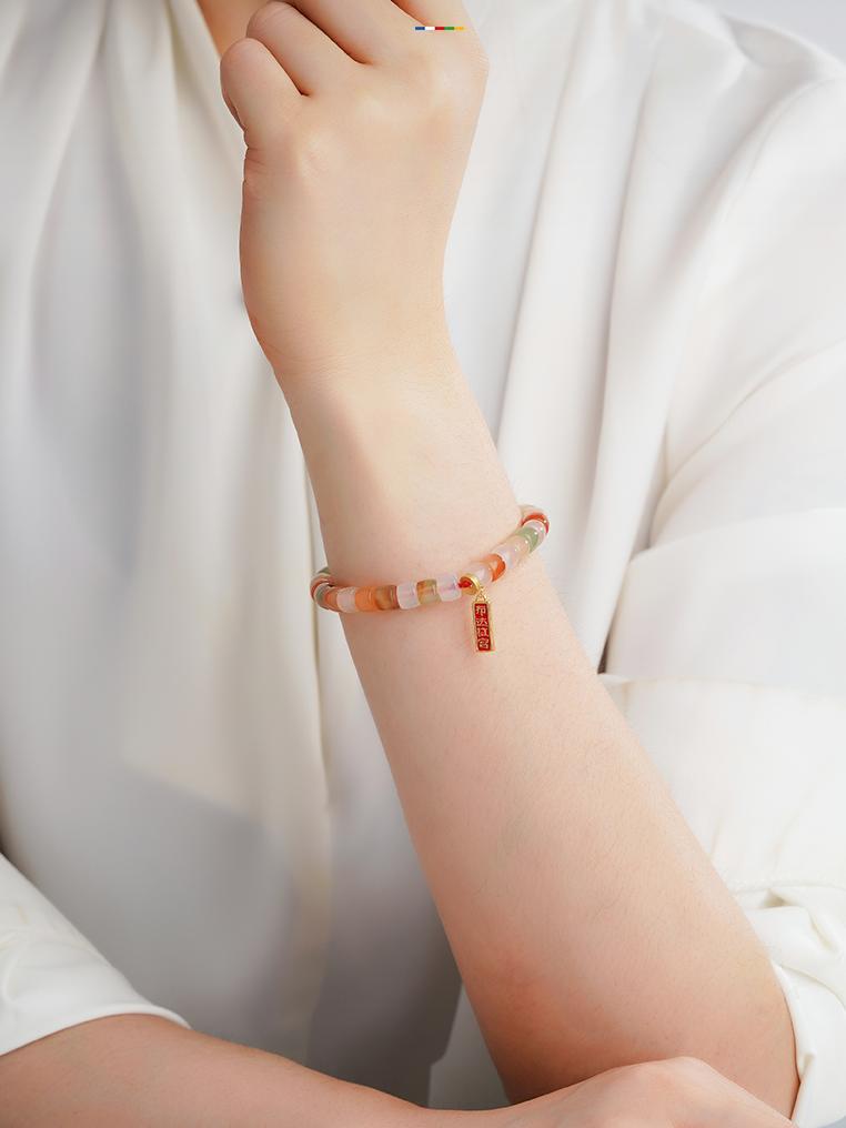 Tibetan Buddhist Jewelry Art: A beautiful Hand-Painted Light Agate Charm Bracelet with sacred symbols for protection and good fortune.