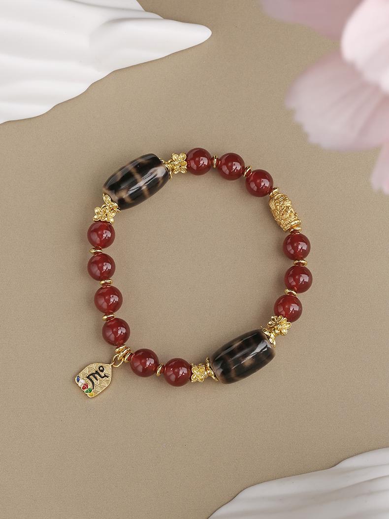 Tibetan Buddhist Jewelry Art: Dzi Red Agate Spiritual Bracelet featuring traditional Tibetan Buddhist prosperity symbols