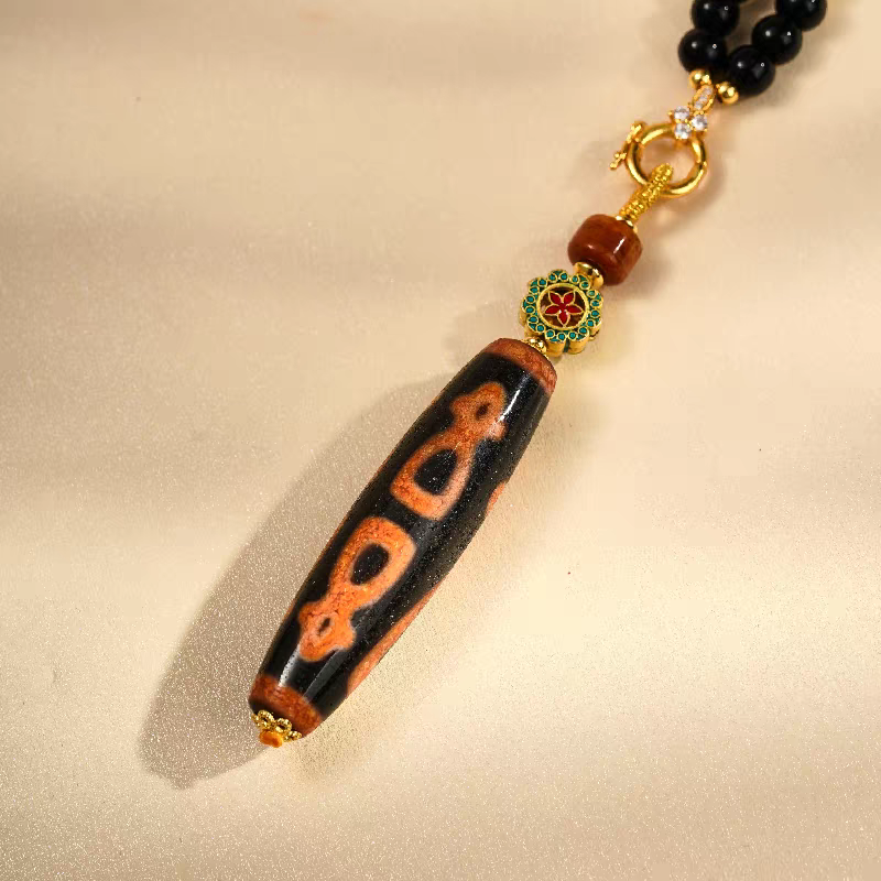 Handcrafted jewelry art pendant featuring the five wealth gods Dzi, representing abundance and prosperity in Tibetan traditions.
