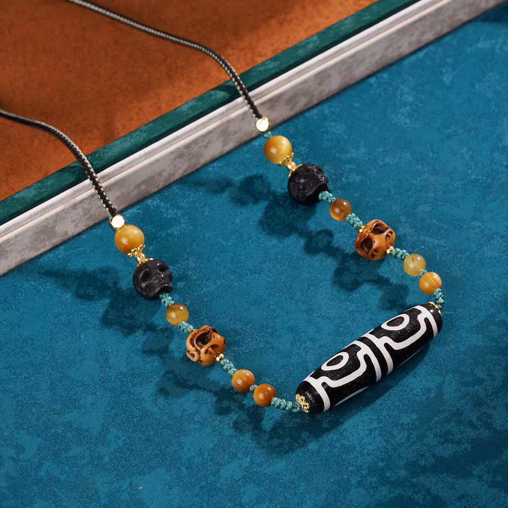 Exquisite four-eyed natural agate Dzi jewelry with mandala pattern, a spiritual artifact rooted in Tibetan Buddhist Jewelry Culture for balance.