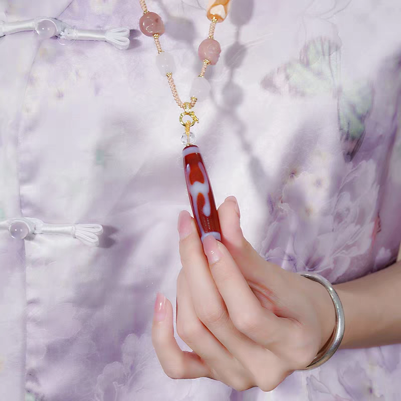 Exquisite Green Tara spiritual jewelry in red meat agate, a rare artifact rooted in Tibetan Buddhist Jewelry Culture for swift blessings.