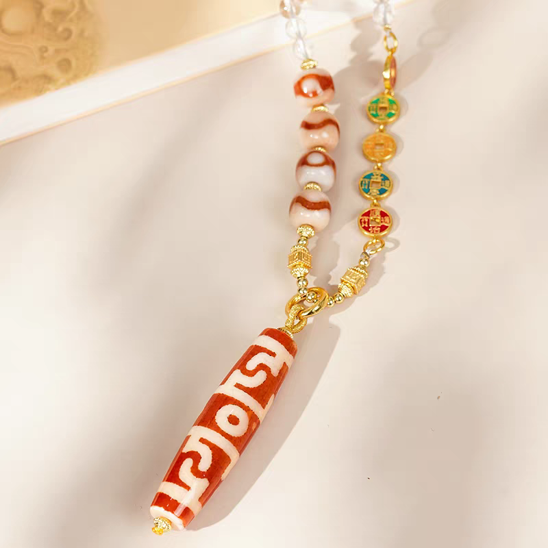 Exquisite Guru Rinpoche ritual implements pendant in red agate, a spiritual artifact rooted in Tibetan Buddhist Jewelry Culture for protection.
