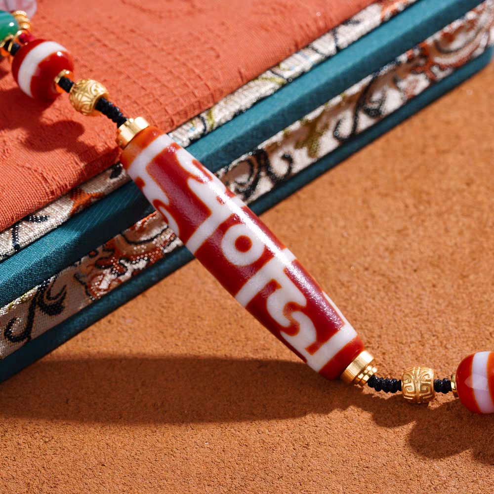  Exquisite Guru Rinpoche ritual implements pendant in red agate, a spiritual artifact rooted in Tibetan Buddhist Jewelry Culture for protection.