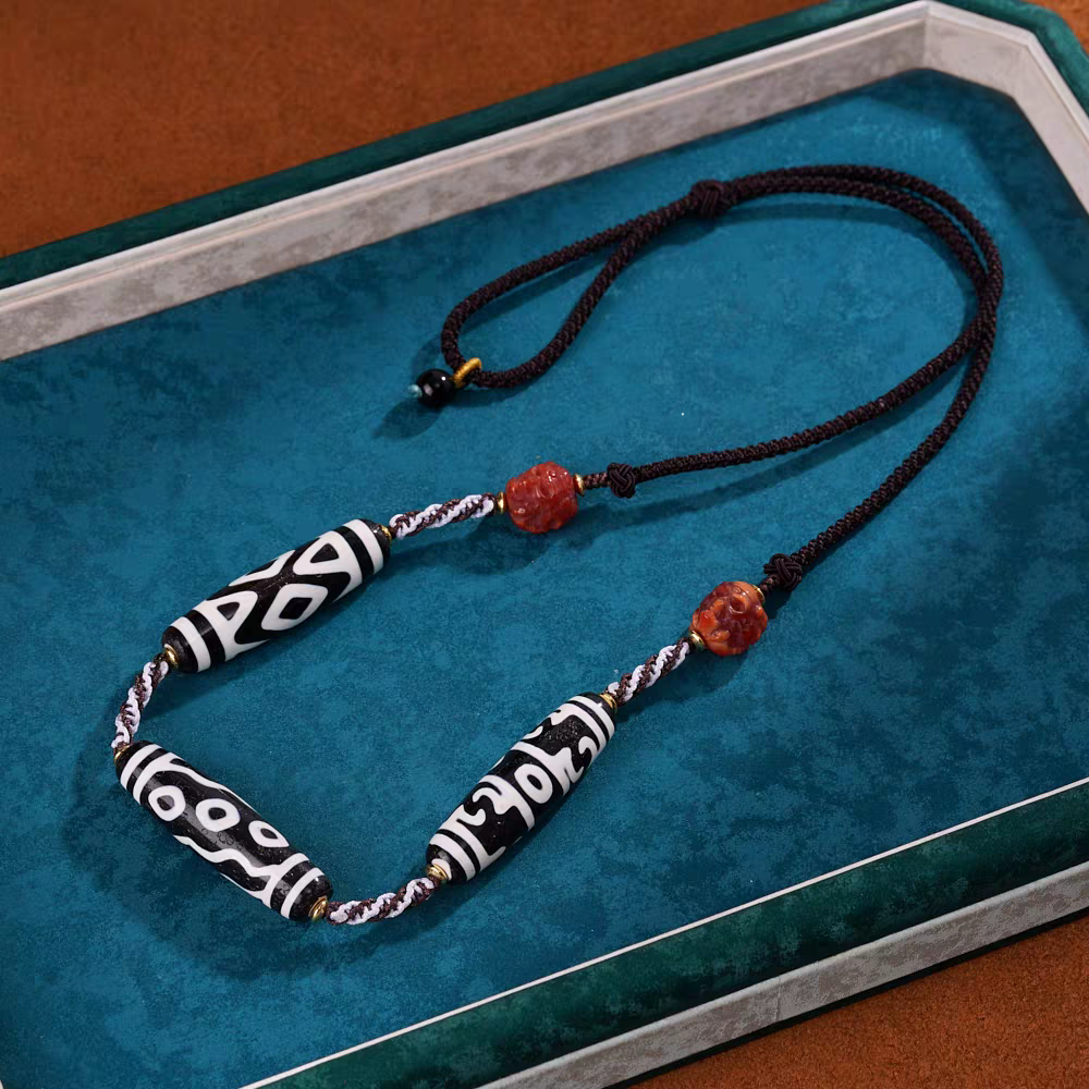 Handcrafted jewelry art clavicle necklace featuring sacred six-eye Dzi, representing the six perfections and spiritual insight.