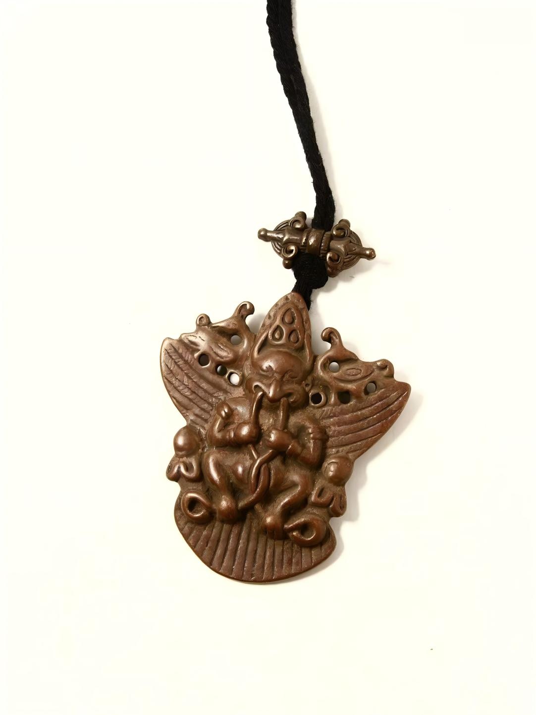 Handcrafted Kun Gang Phoenix golden winged bird figure, made from Lima copper in Tibetan Buddhist Jewelry Culture, symbolizing strength, protection, and spiritual power.