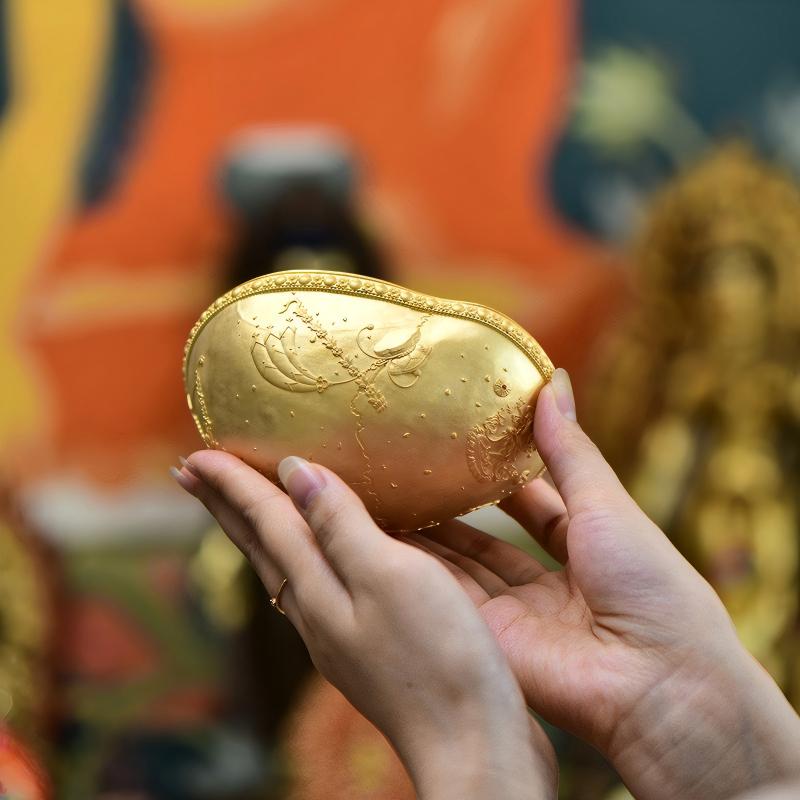 Tibetan Buddhist Jewelry Culture: Traditional Kurukulla treasure vase for attracting good fortune, reflecting ancient Tibetan Buddhist sacrificial implements culture.