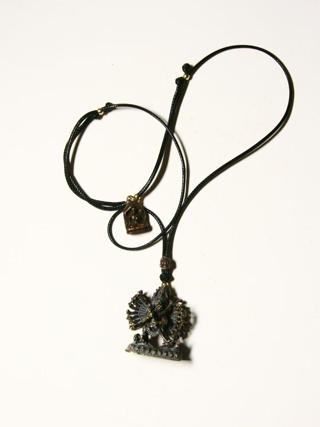 Handcrafted White Jambhala Buddha statue with Six-Armed Mahakala and Tianwang, symbolizing wealth, protection, and divine energy in Tibetan Buddhist Jewelry Art.
