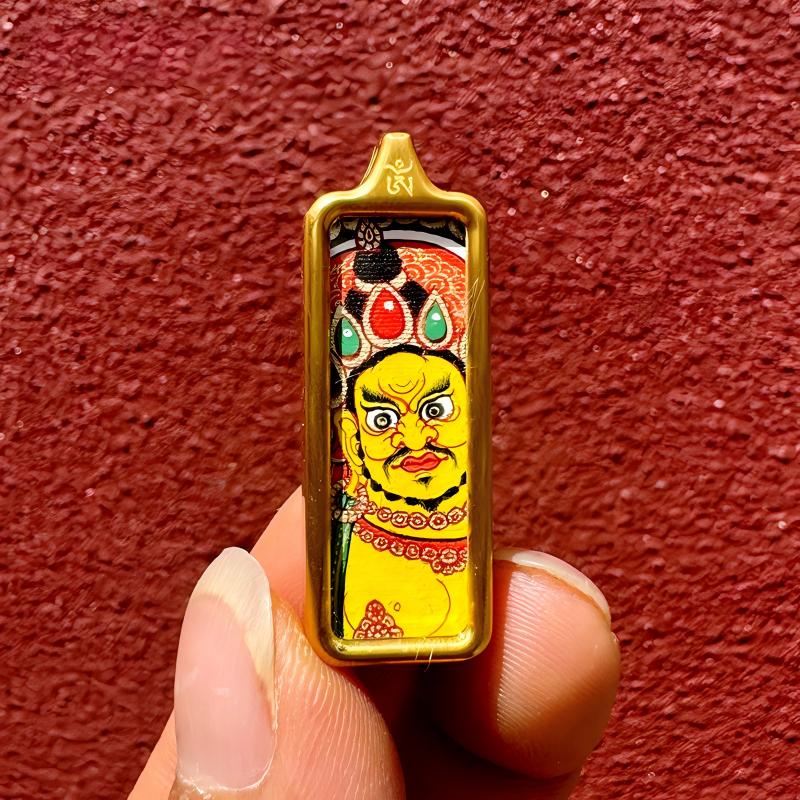 Yellow Jambhala hand-painted Thangka rooted in Tibetan Buddhist Jewelry Culture, handcrafted Jewelry art for wealth, prosperity, and protection