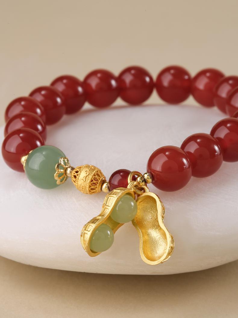  Wearing style of Hand-Painted Morning Blossom Agate Spiritual Bracelet. Shows how the bracelet looks on wrist, with warm red agate tones complementing skin tone, both dignified and fashionable.