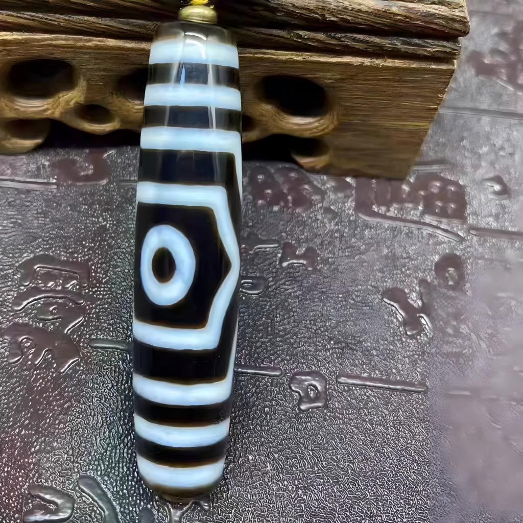 Handmade natural Nine-Eye Dzi pendant for men and women, Tibetan Buddhist Jewelry Culture-inspired jewelry art enhancing luck, protection, and balance.